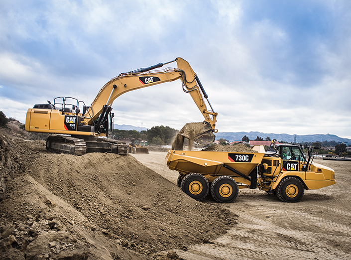 CAT equipment dumping dirt into CAT truck