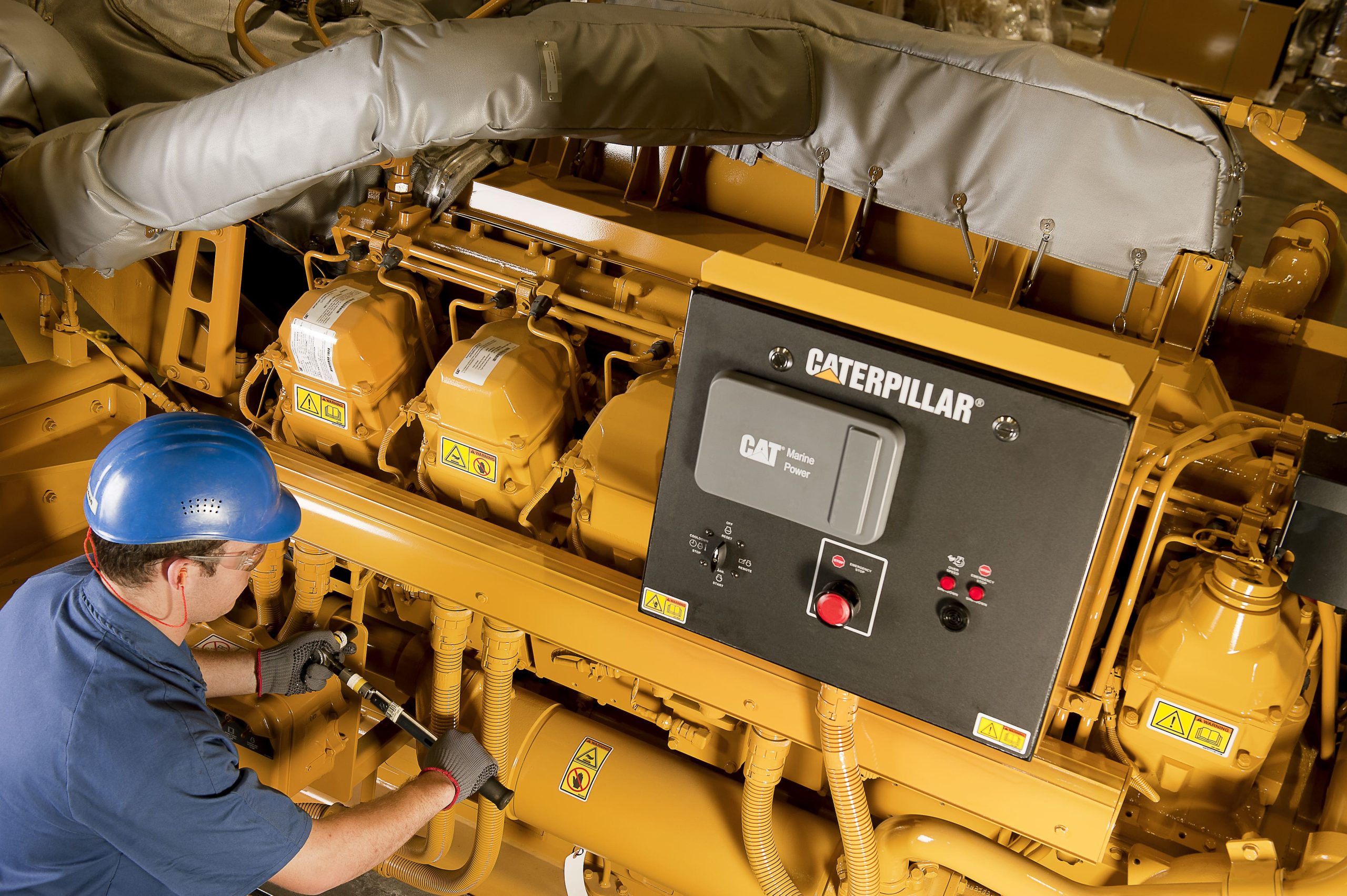 worker doing maintenance on CAT machine