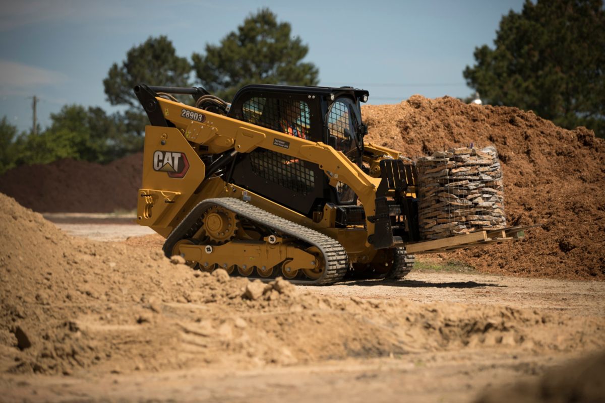 CAT compact equipment transporting rocks